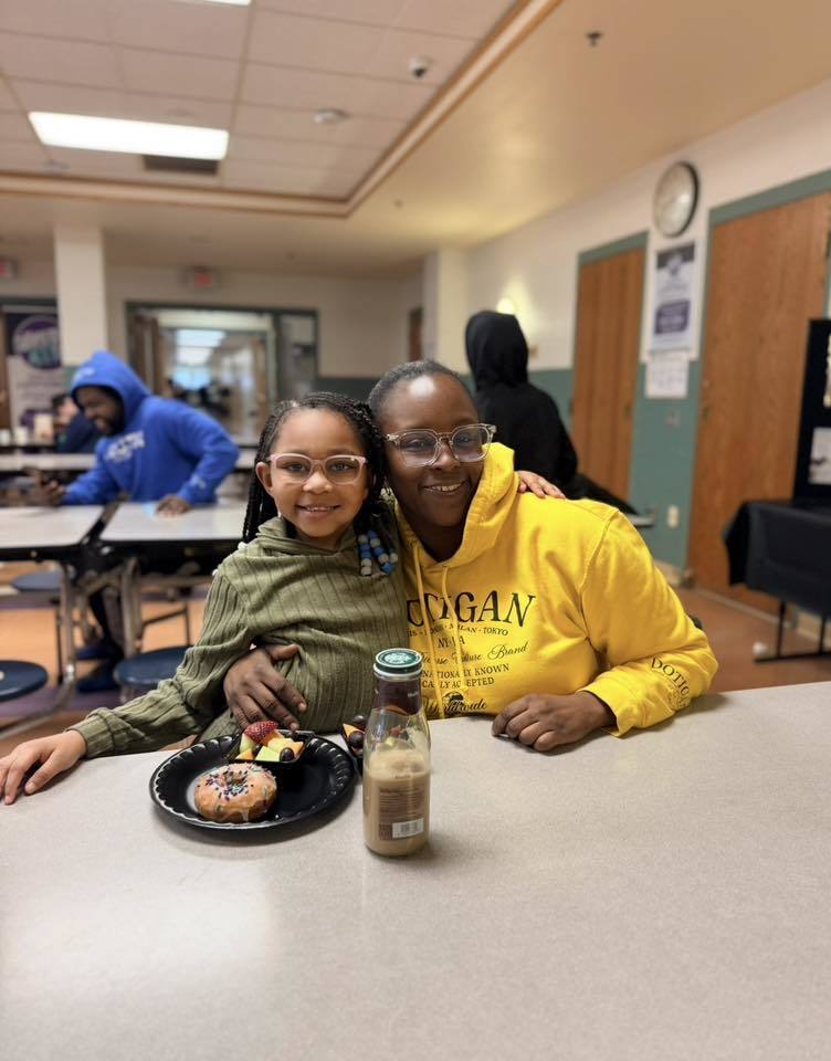 A student with their family eating breakfast at school.