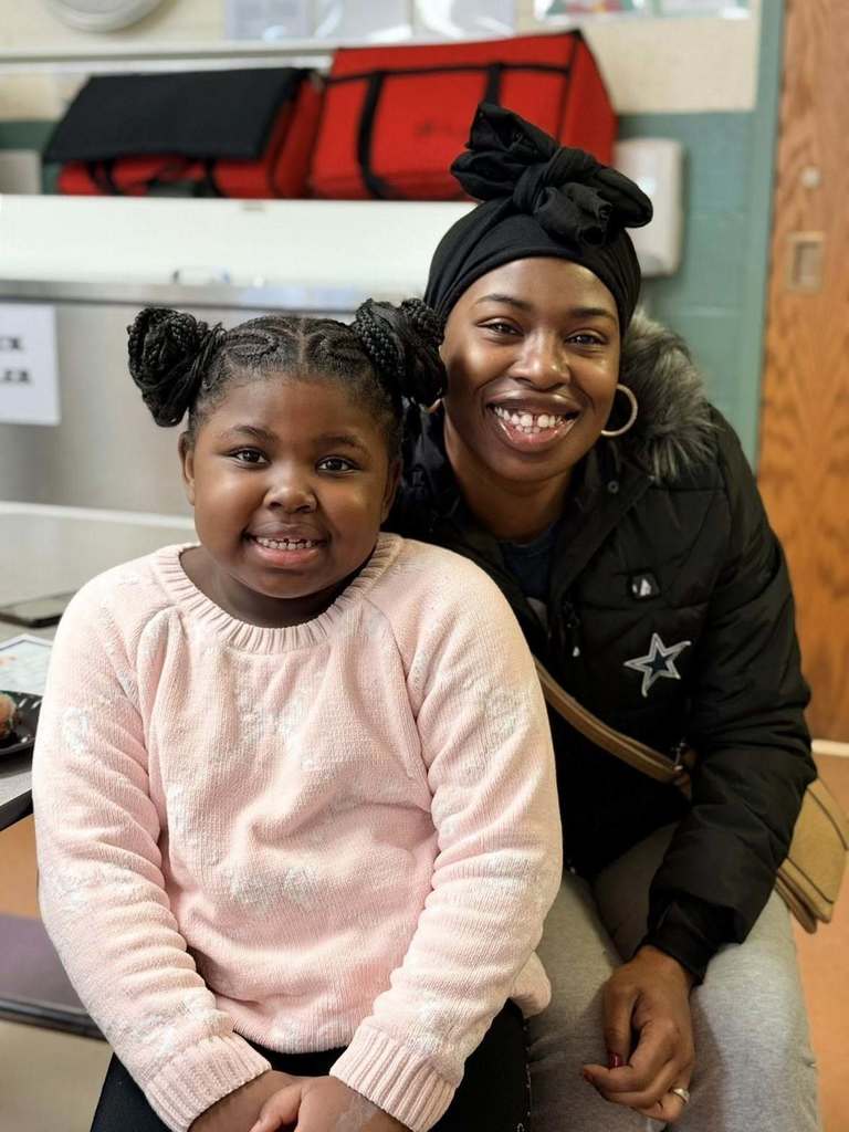 A student and her parent smilng. 