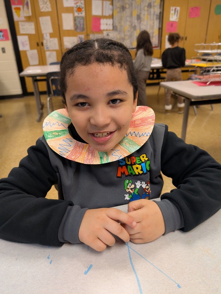 A student that put a necklace drawing they created around their head.