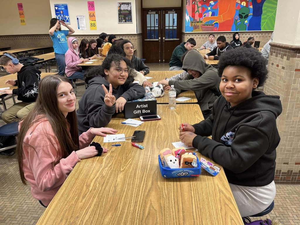 Students playing a game in a school cafeteria.