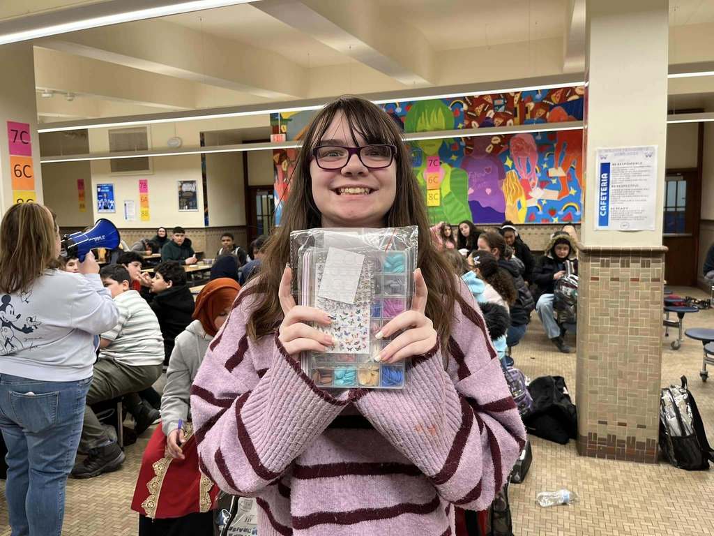 A young girl holding a nail kit in her hands.