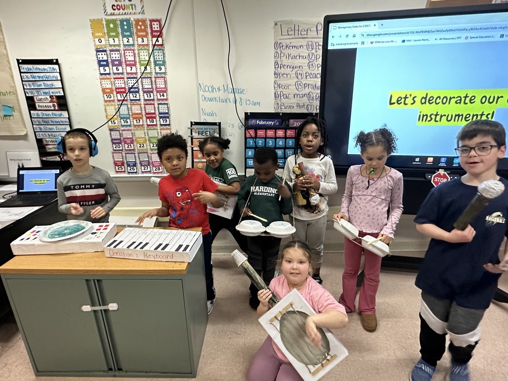 Students pretending to play the instruments they crafted. 