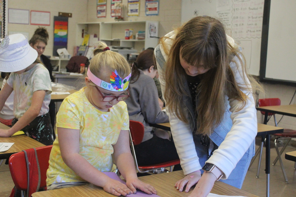High school students working with 2nd grade students to build airplanes! 