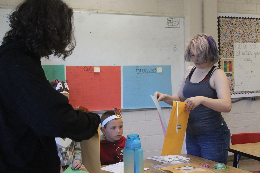 High school students working with 2nd grade students to build airplanes! 