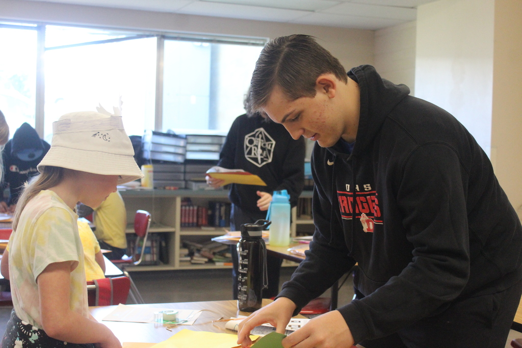 High school students working with 2nd grade students to build airplanes! 