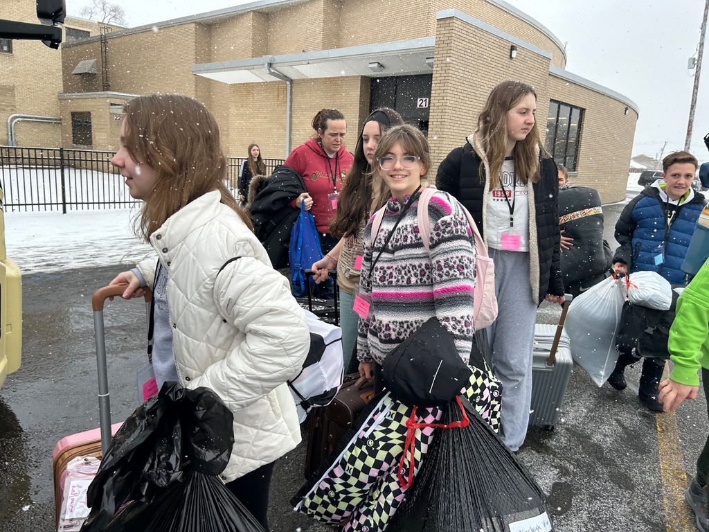 students in line to load luggage