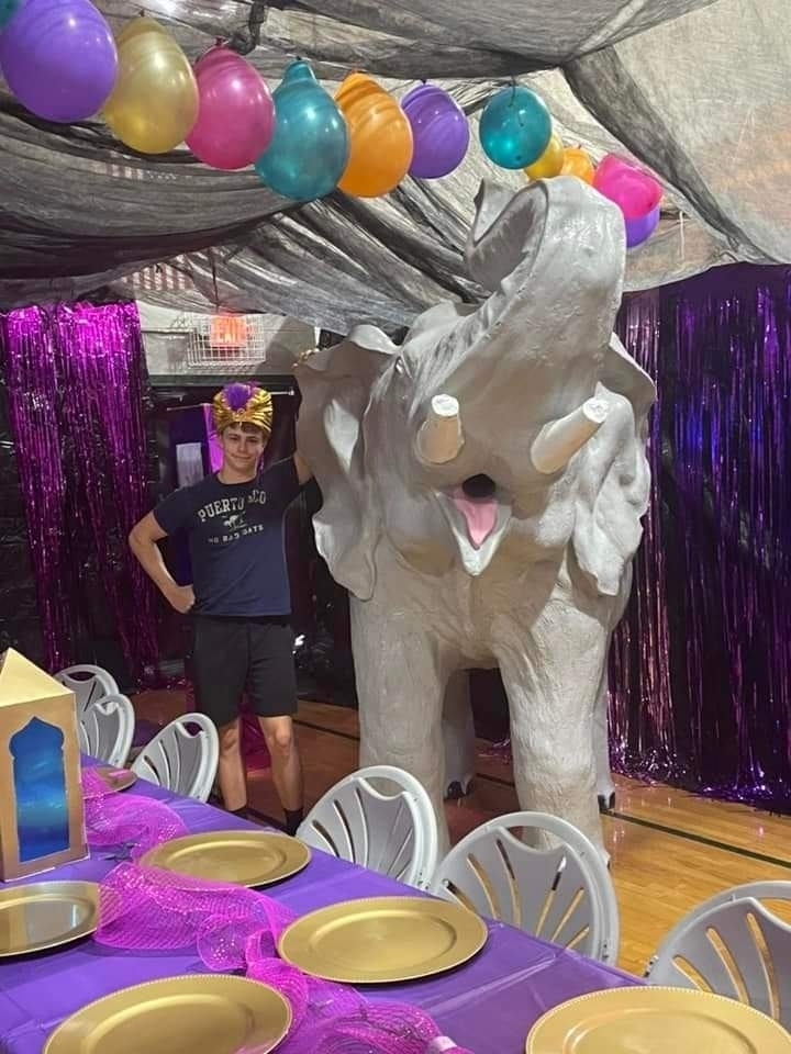 Connor Witt standing next to an elephant statue.