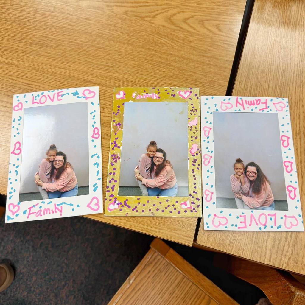 Pictures frames decorated with a photo of an adult and child. 