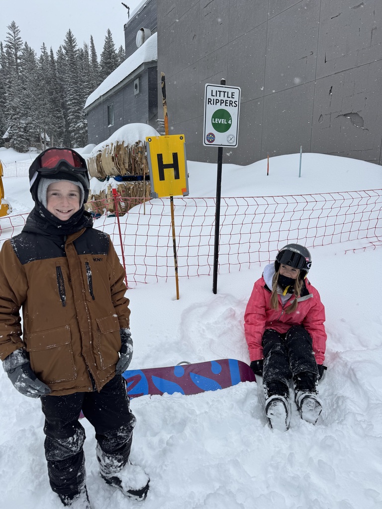 Two snow boarders taking a break