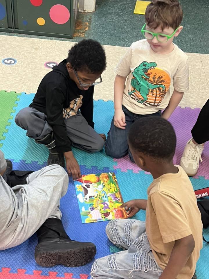Students putting together a puzzle. 