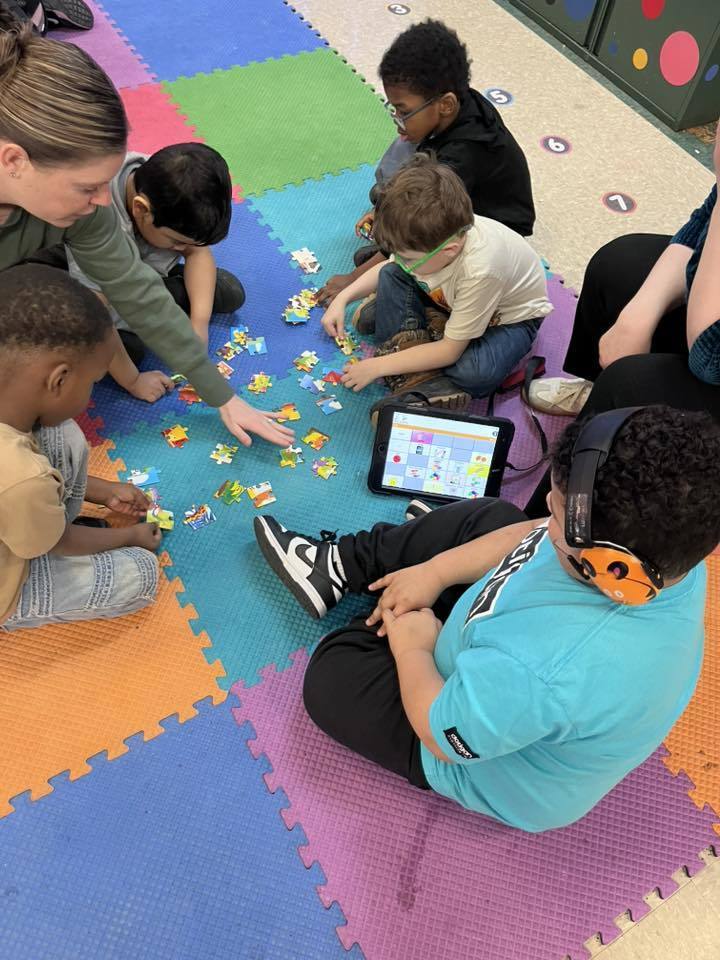 Students putting together a puzzle. 