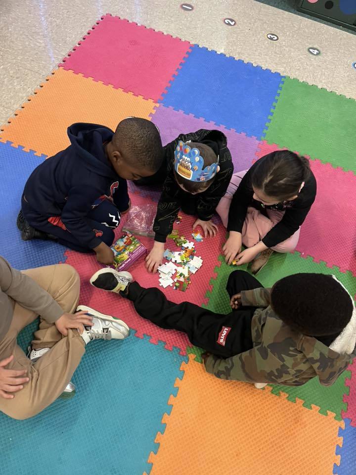 Students putting together a puzzle. 