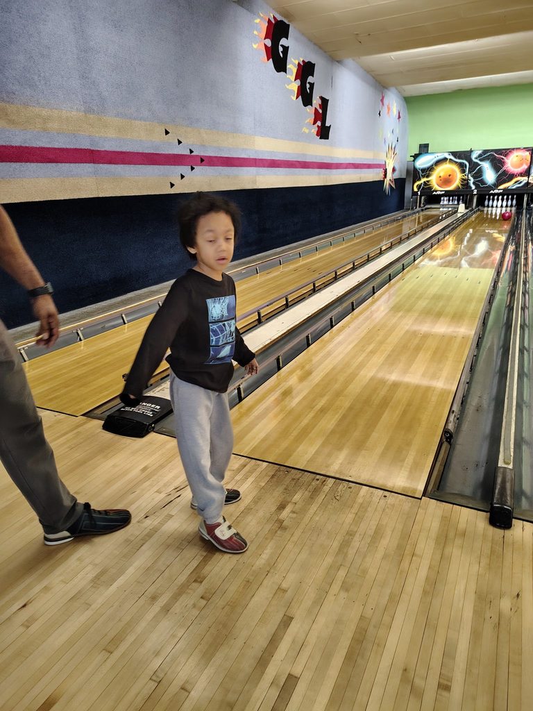 A child bowling. 