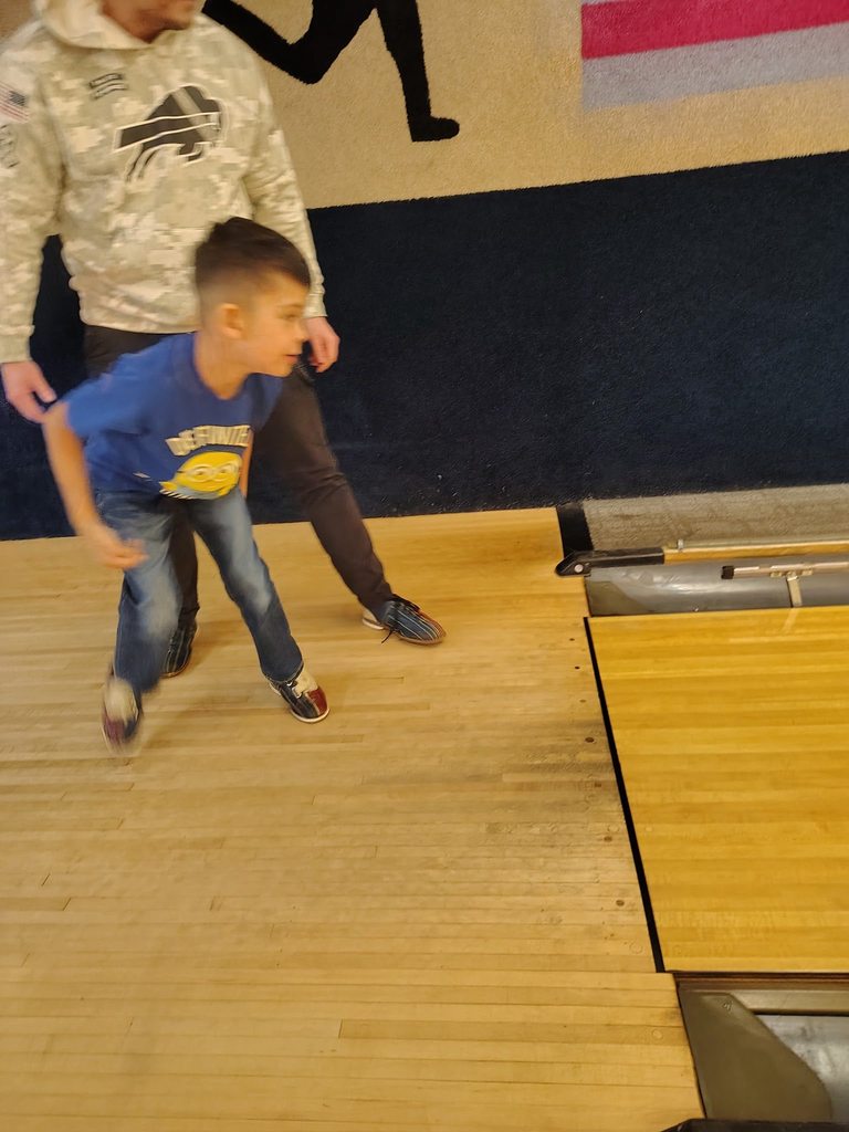 A child bowling. 