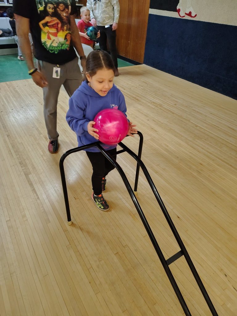 A child bowling. 
