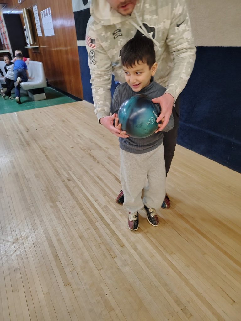 A child bowling. 