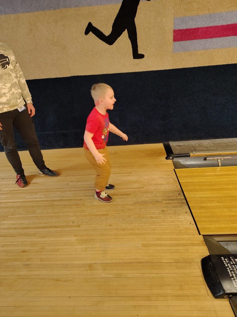 A child bowling. 