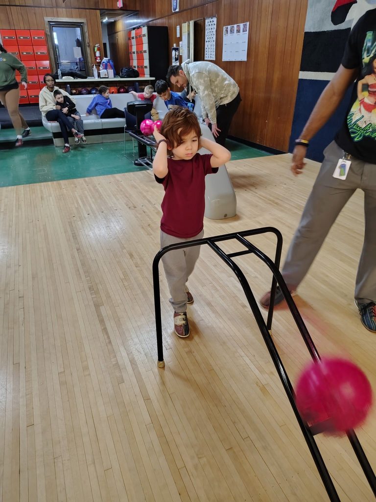 A child bowling. 