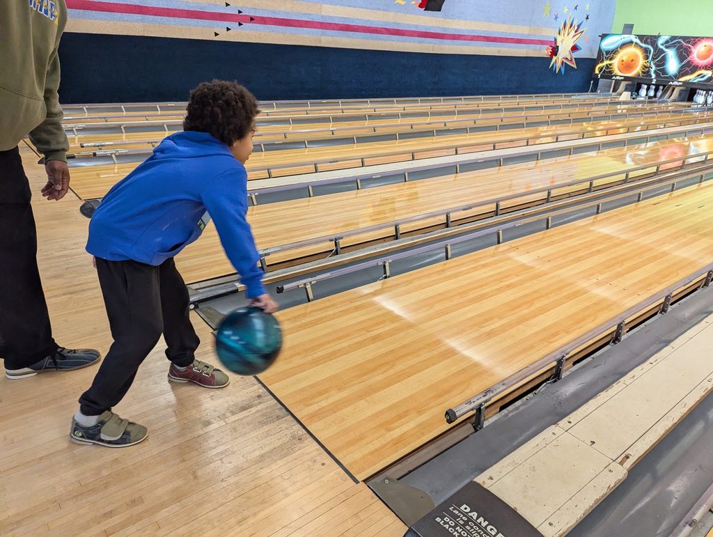 A kid bowling.