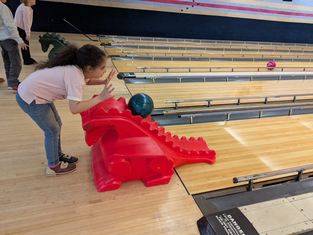 A kid bowling. 