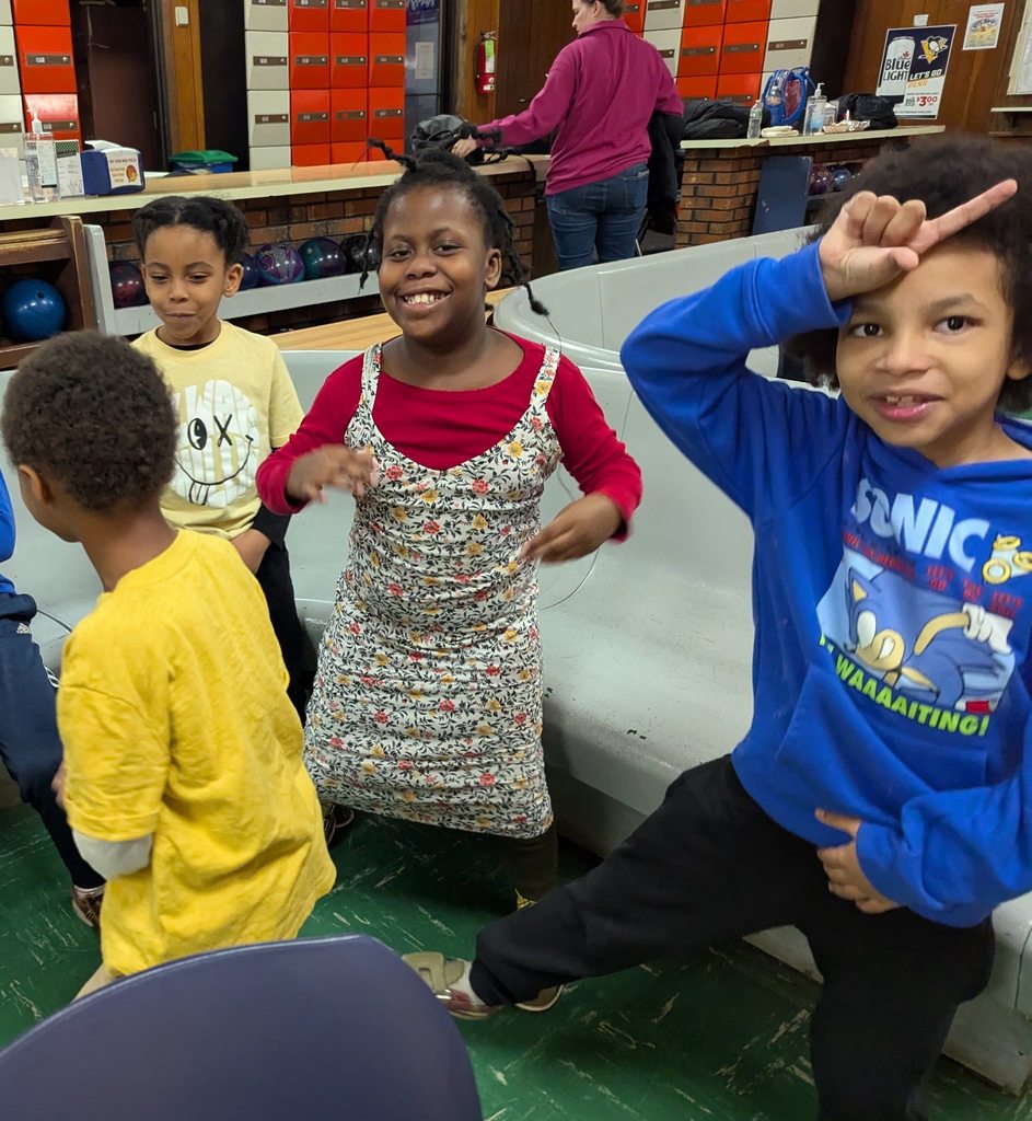 Students smiling at a bowling ally and dancing.