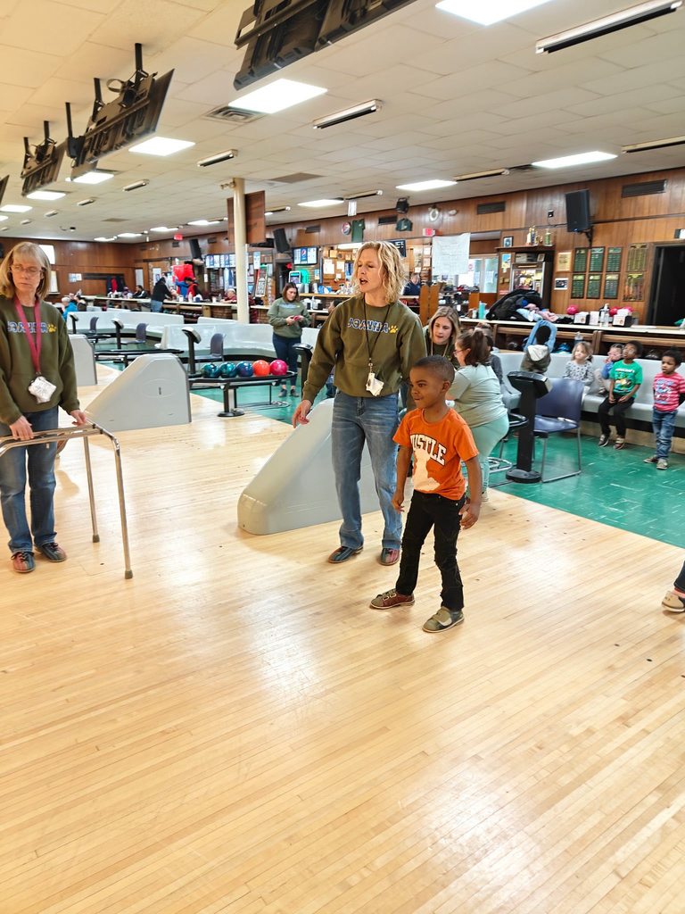 People standing in a bowling ally. 