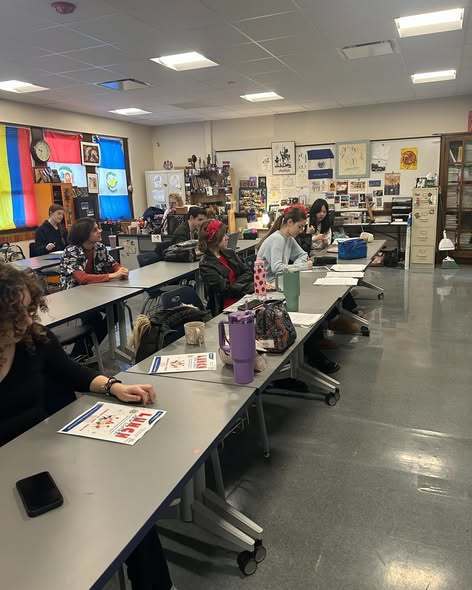 Students in a classroom sitting.