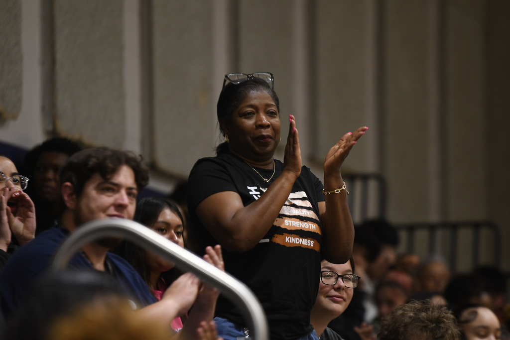 woman clapping in the stands