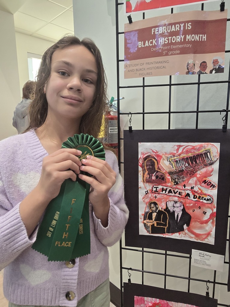 Student poses with winning artwork.