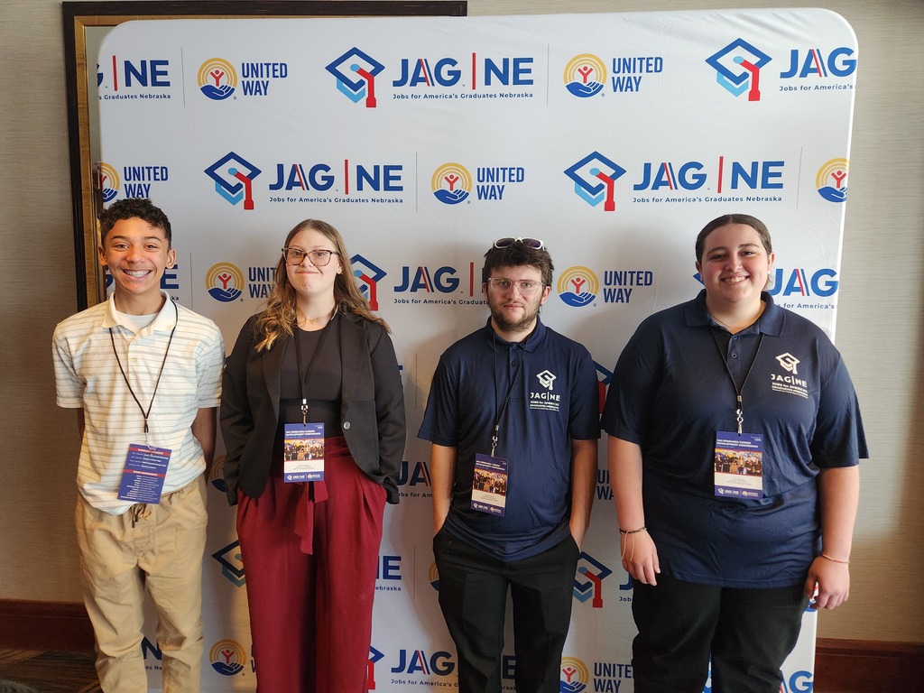 4 JAG students smiling ready to start the day of competition, networking, and learning!
