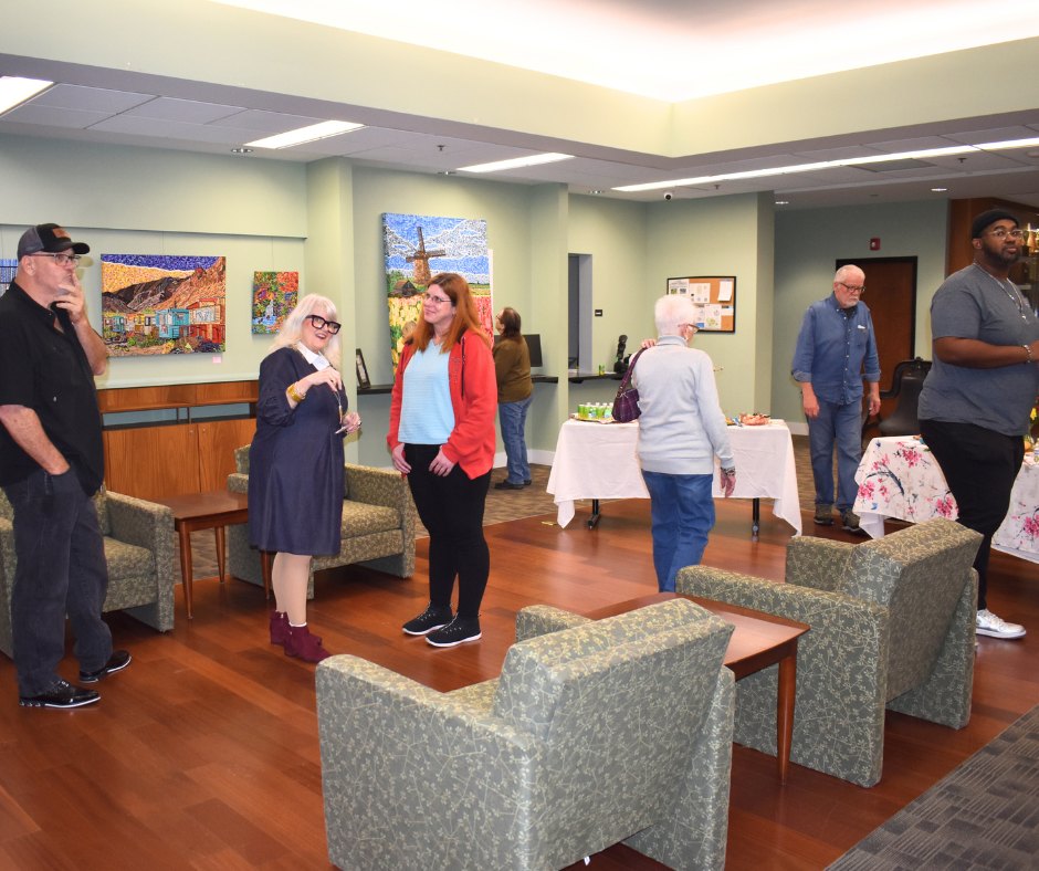 a group of people in the lobby at townhall at a reception for art
