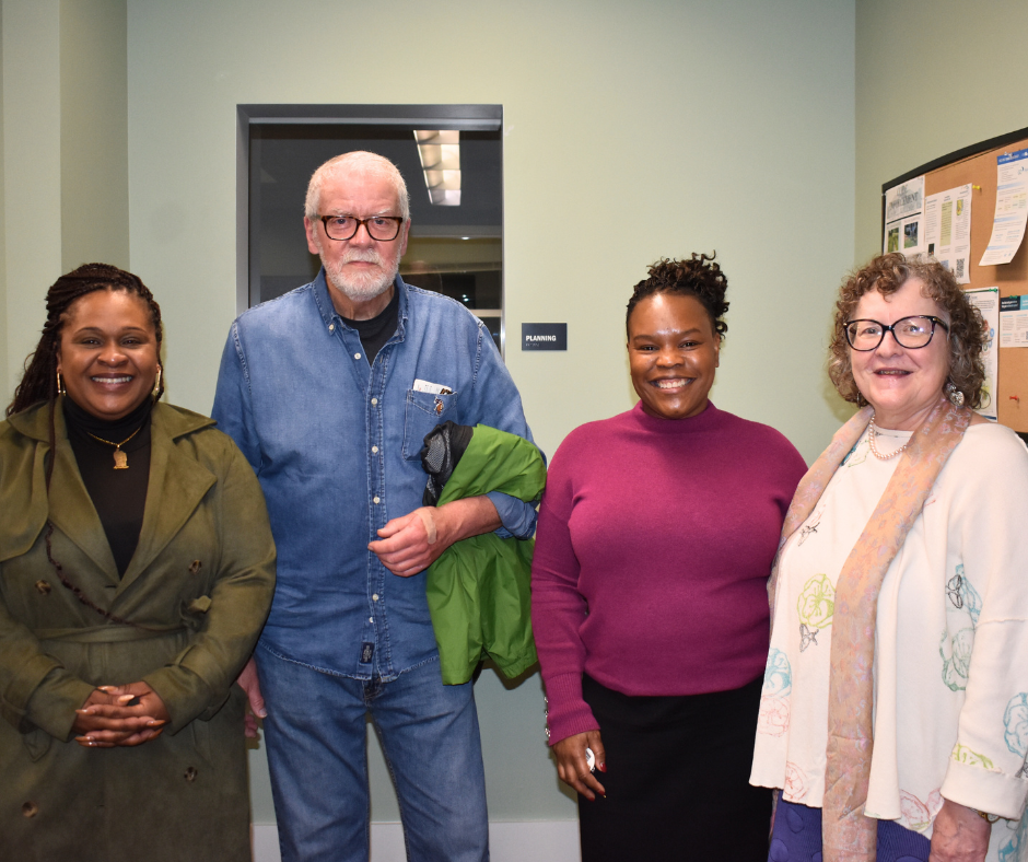 four people standing together