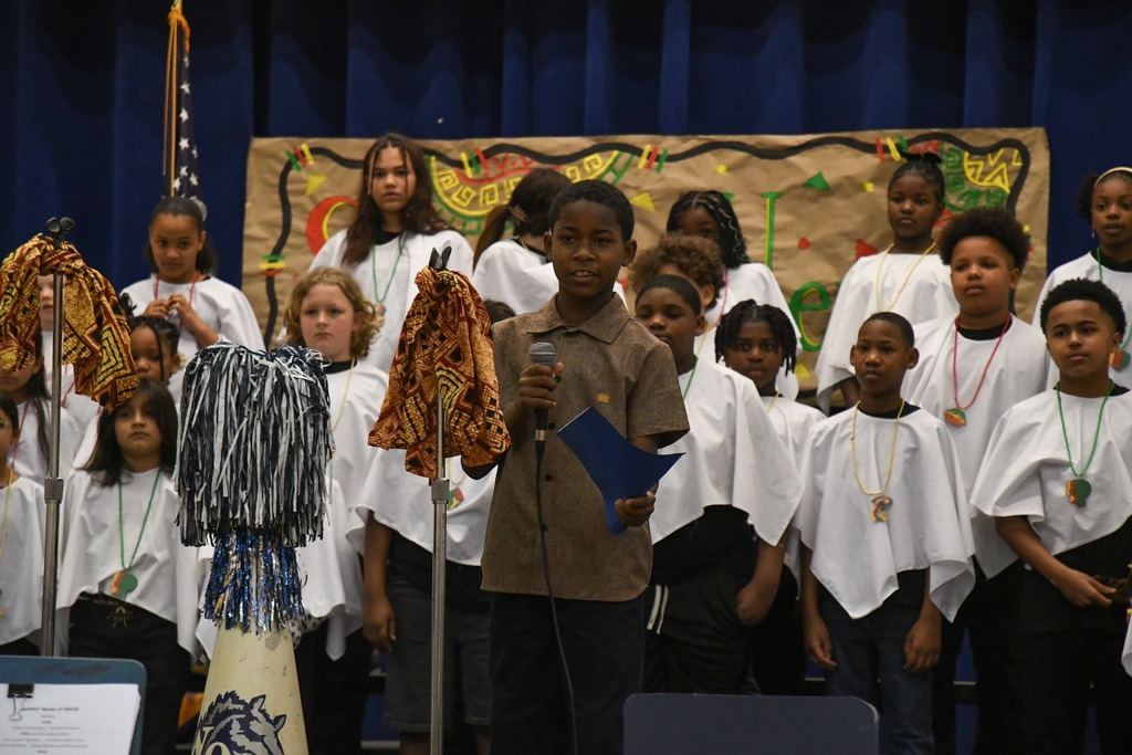 students speaking on stage