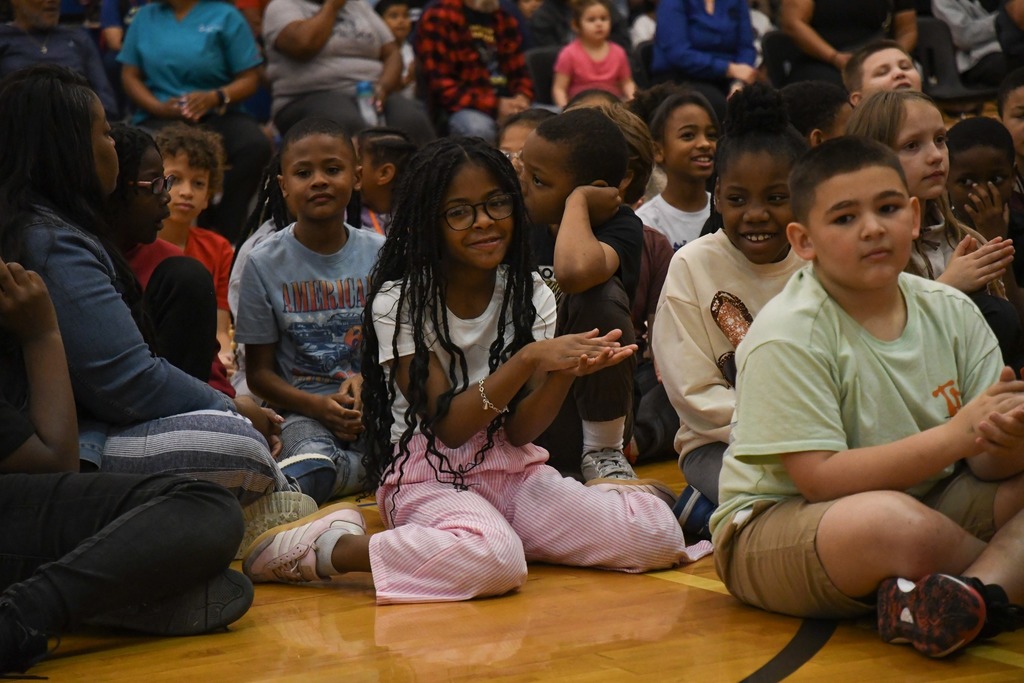 student clapping in crowd