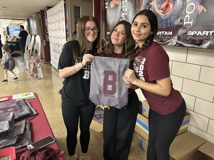 three BHS girls holding a kindergarten swag bag