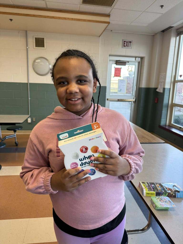A kid holding what they won. 