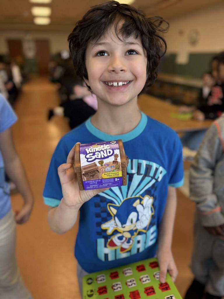 A kid holding a small sandbox.