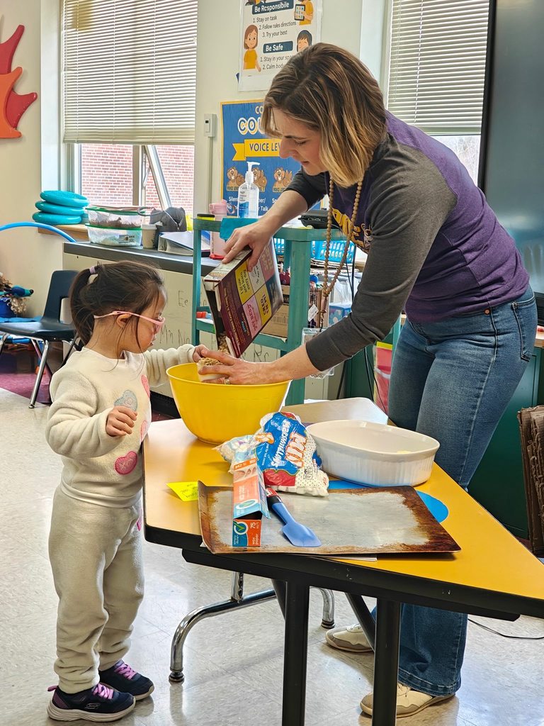A teacher teaching students how to cook in class with hands on experience. 