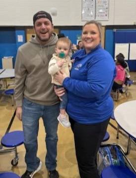 Two adults and a baby.