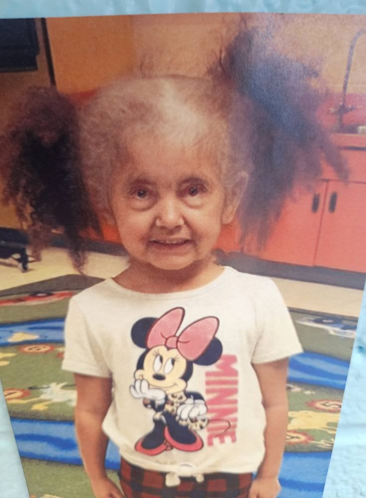 A photo of a student with a filter on to make them look like an elderly person.. 