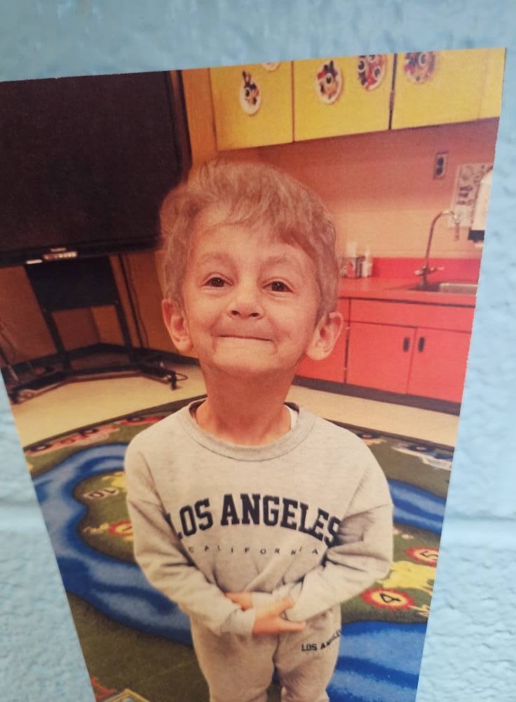 A photo of a student with a filter on to make them look like an elderly person.. 