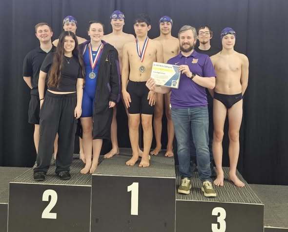 A group of individuals and some are wearing medals they won during teh swim competition. 