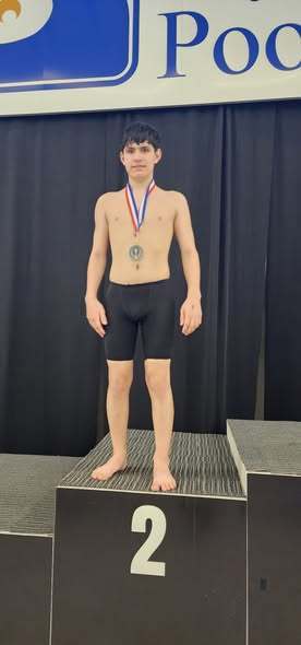 An individual from Erie High that won second place and is wearing a medal. 