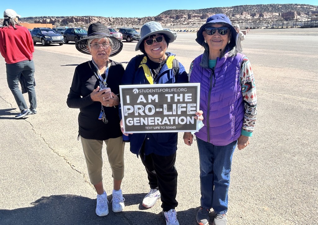 Ladies holding up signs