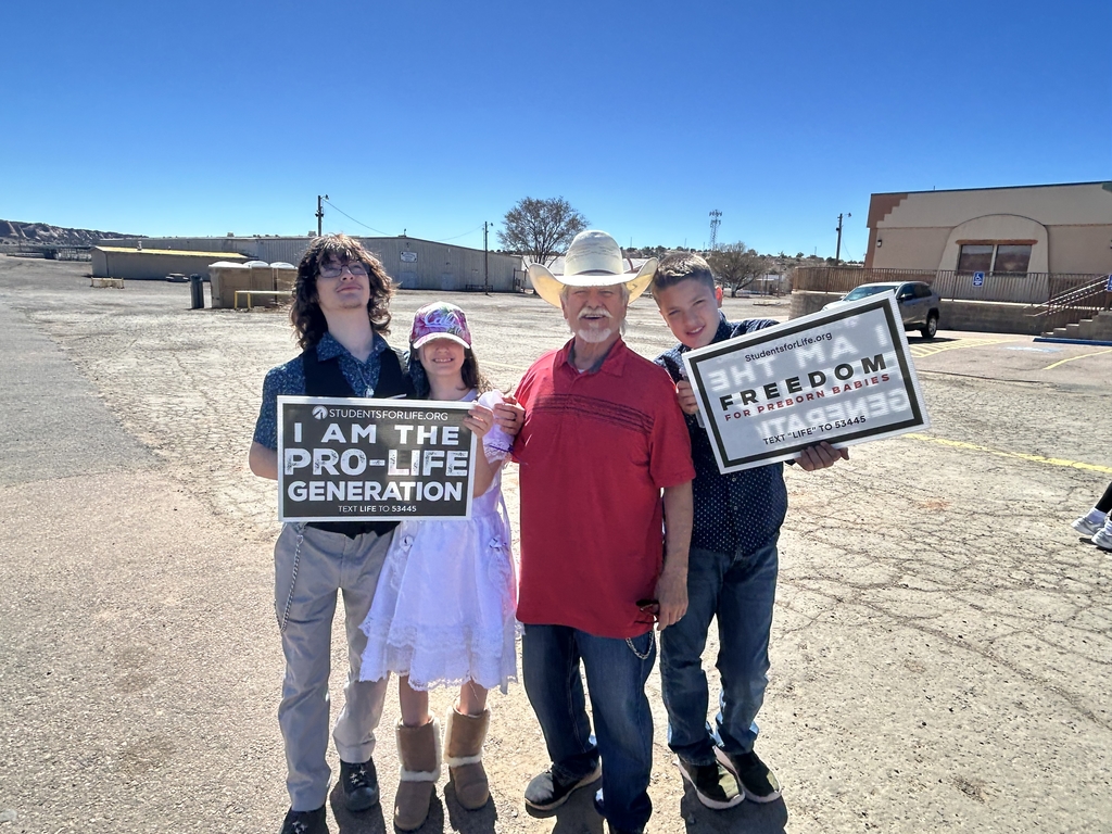 Family holding up signs