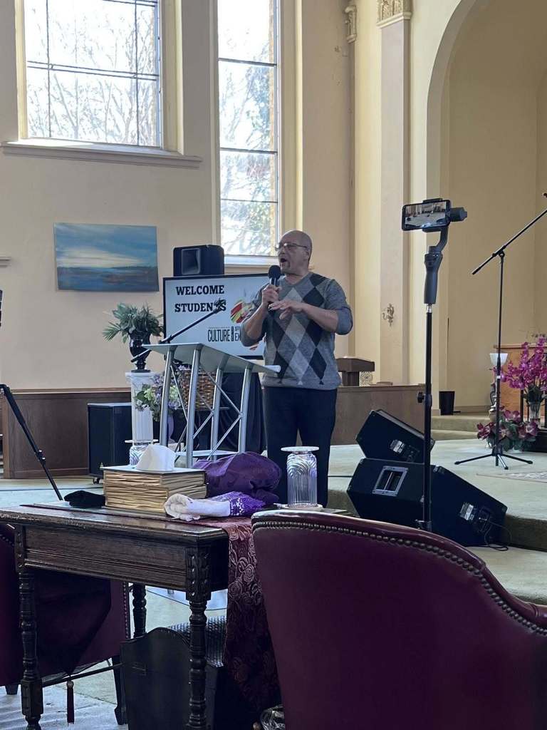 A man speaking in a church. 