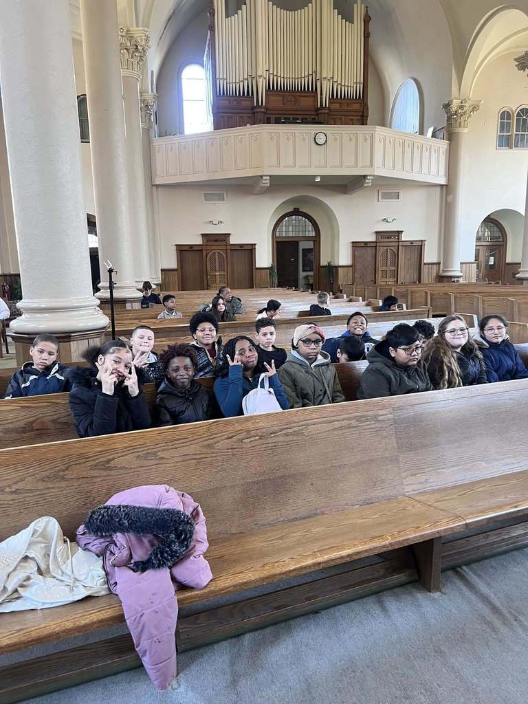 Students sitting in a church. 