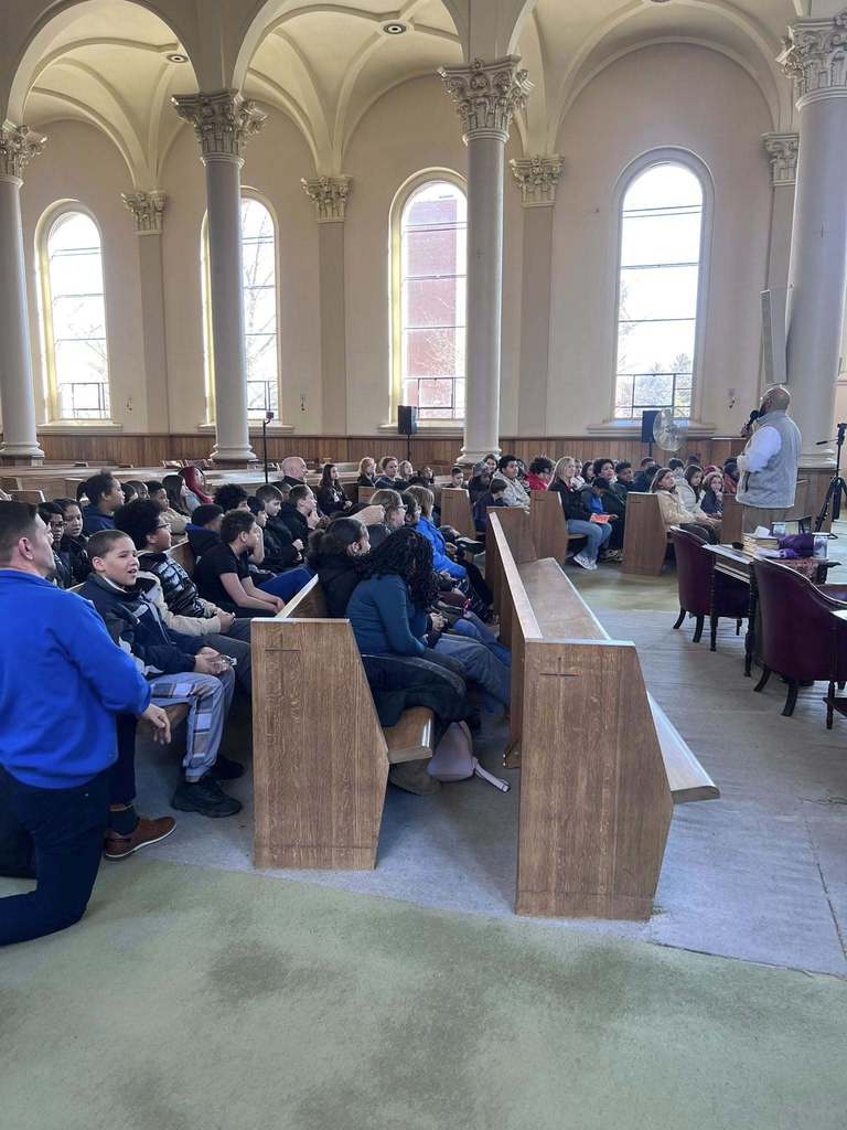 People are sitting in a church. 