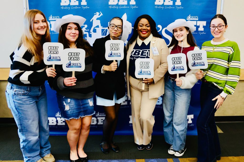 A group of students standing next to Dr. Natalyn Gibbs and holding #B.E.T. fans. 