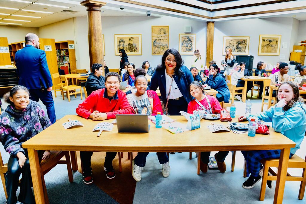 Dr. Natalyn Gibbs and students smiling. 